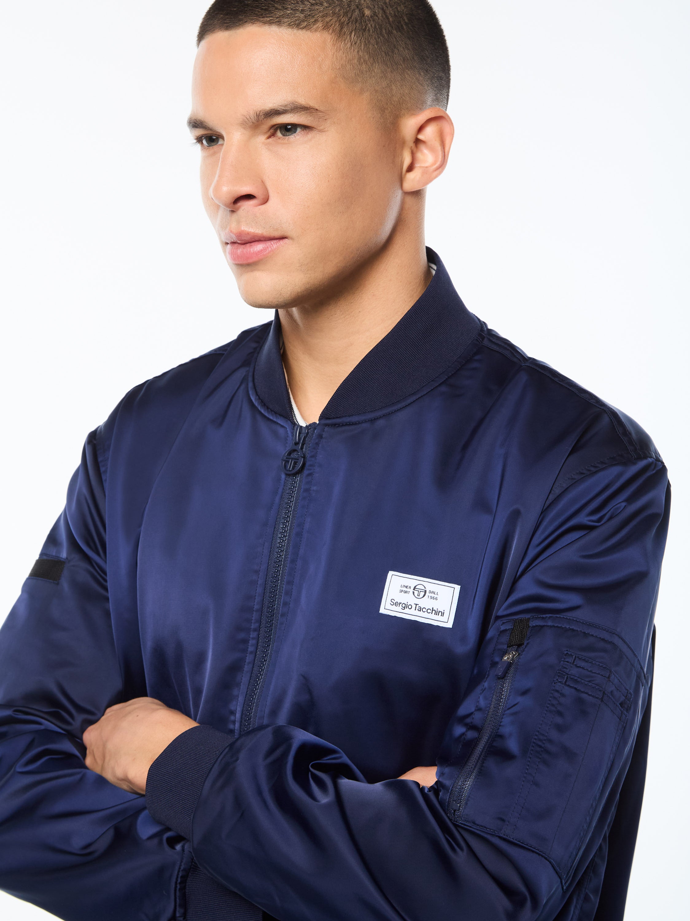 Man wearing a navy blue bomber jacket.