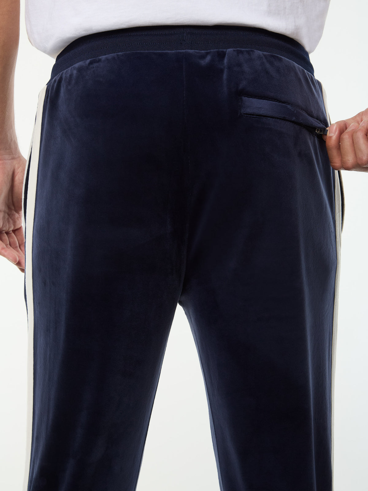 Close-up of the zip back pocket and velour texture on the Damarindo Velour Track Pant in Maritime Blue.