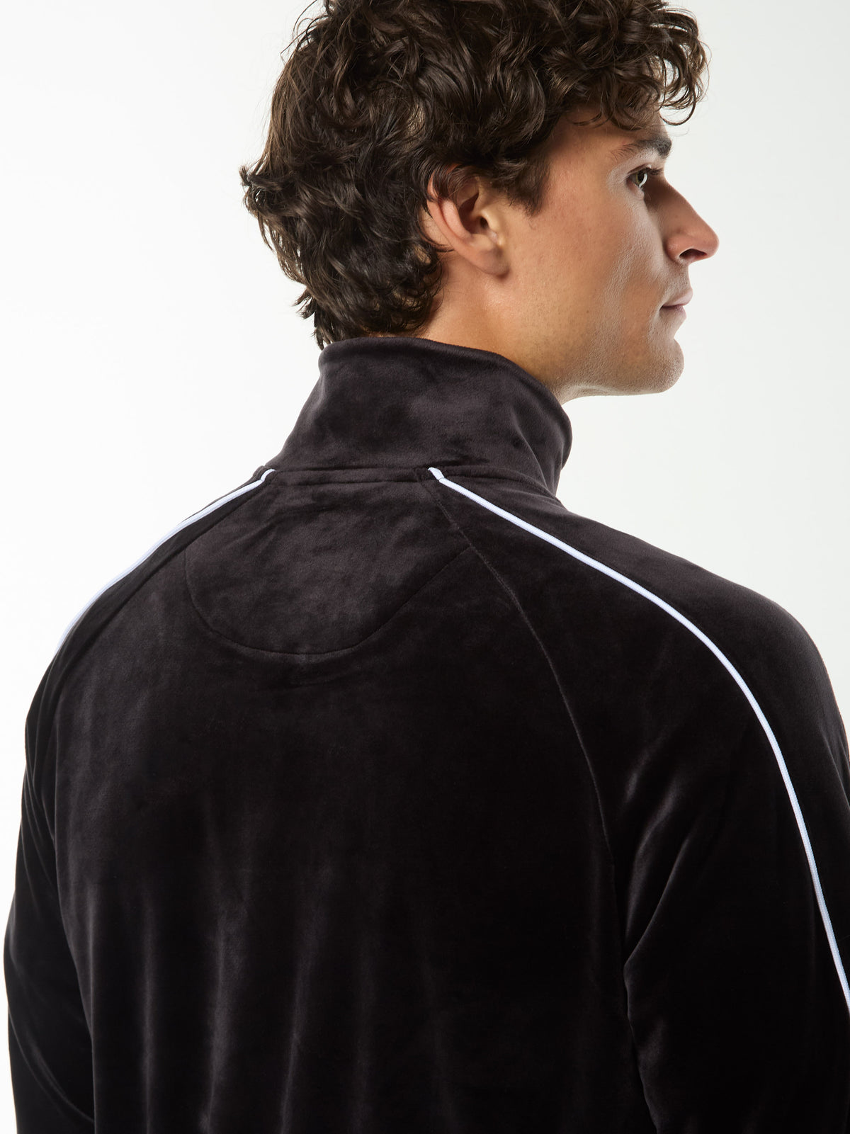 Close-up back view of the collar and white shoulder piping on the Lioni Velour Track Jacket in Black Beauty.