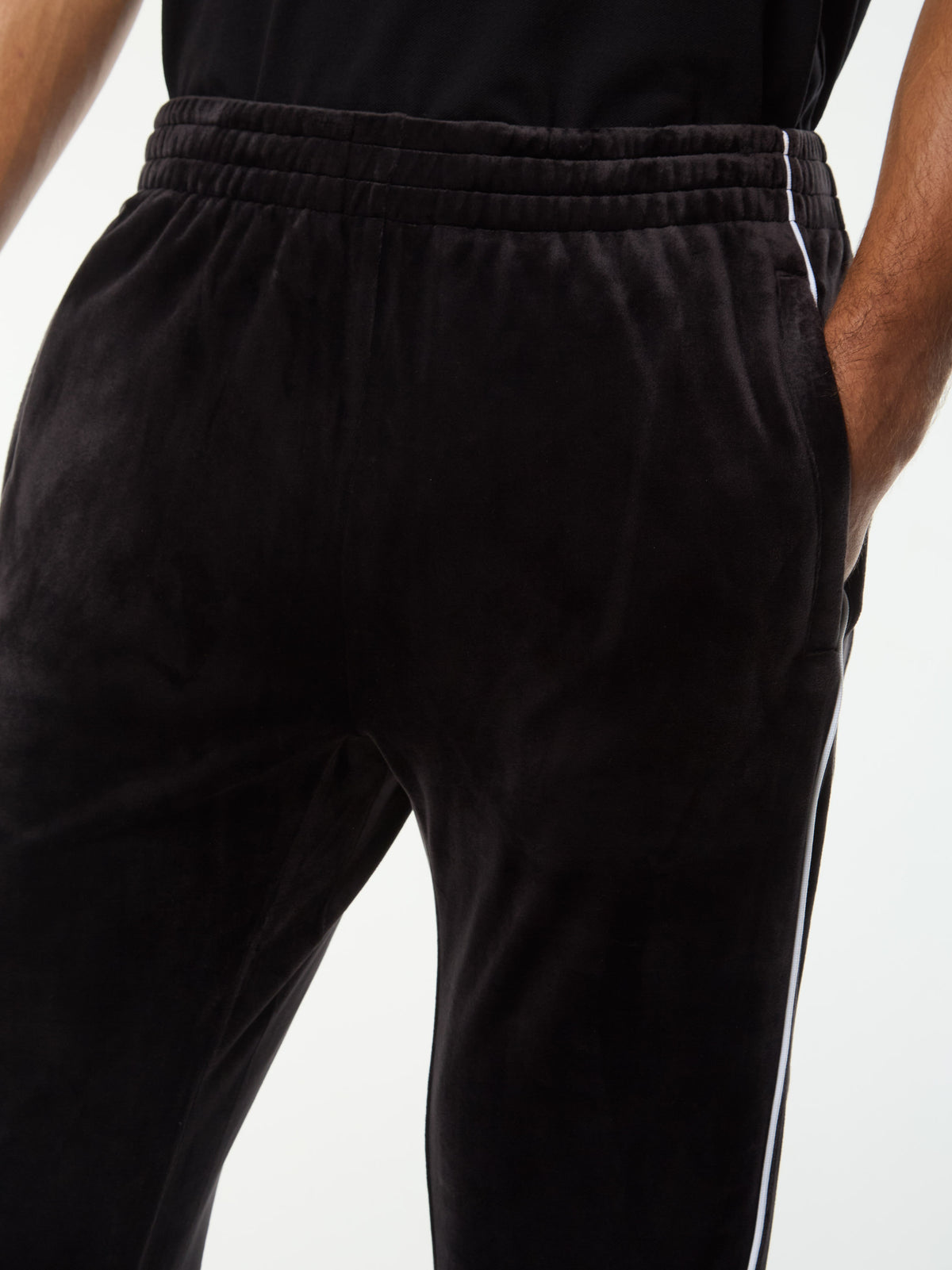 Close-up of the elastic waistband and side piping on the Lioni Velour Track Pant in Black Beauty.