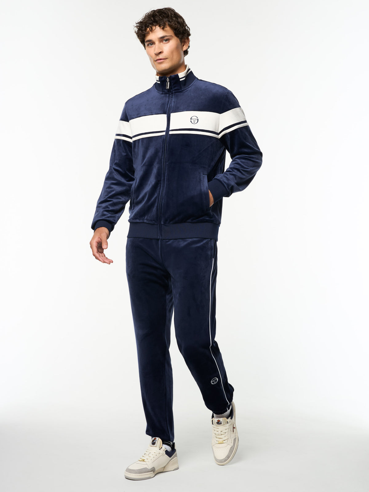 Full body angled view of the Damarindo Velour Track Jacket and matching pants in Maritime Blue.