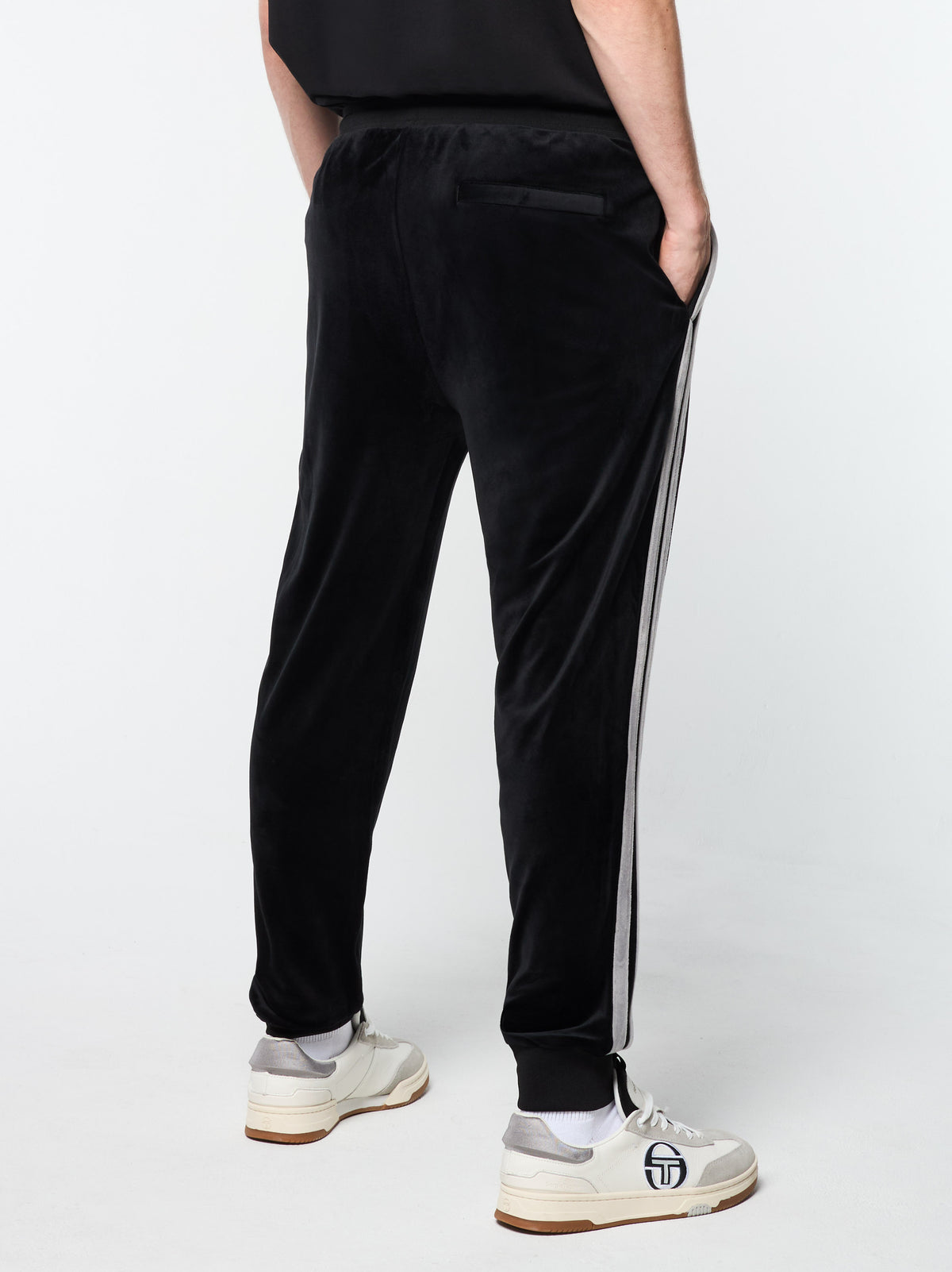 Close-up back view of the pocket and side stripe on the Damarindo Velour Track Pant in Black Beauty.