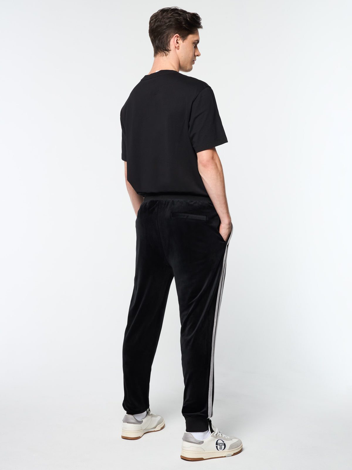 Full back view of the Damarindo Velour Track Pant in Black Beauty on model.