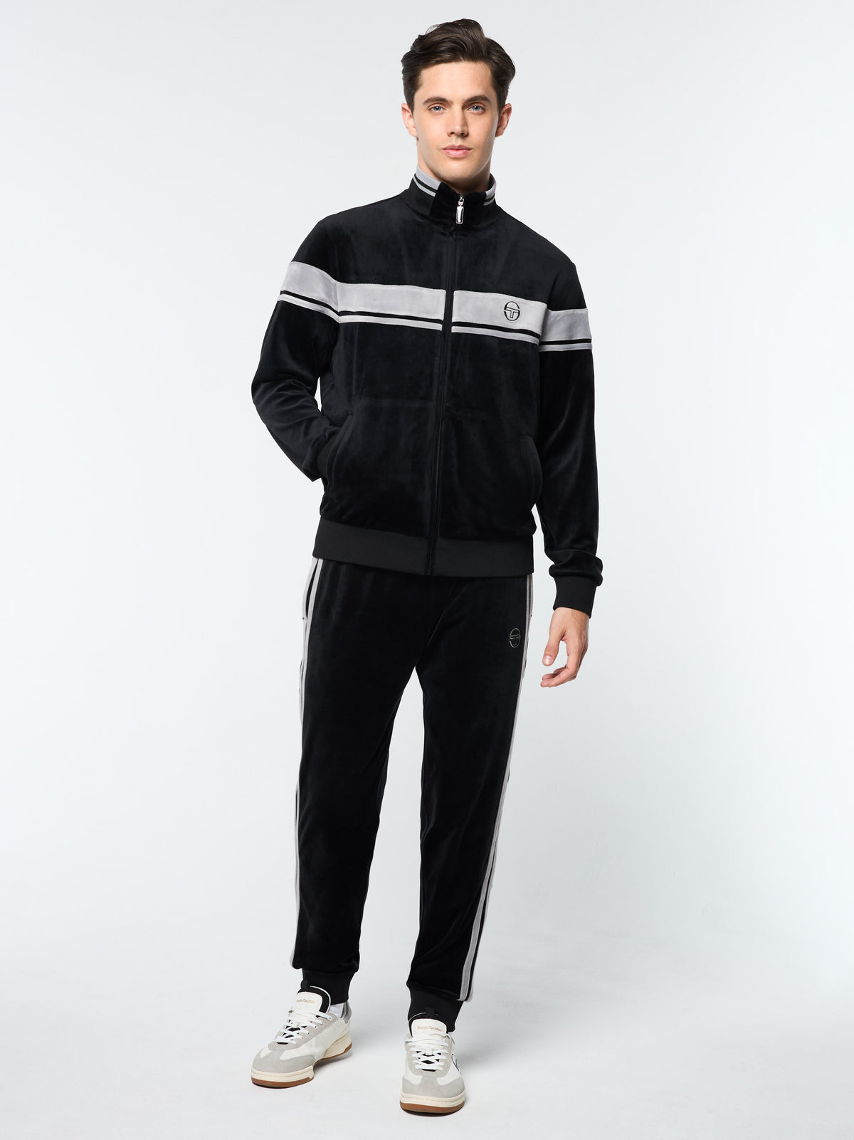 Model wearing the Damarindo Velour Track Jacket and matching pants in Black Beauty.