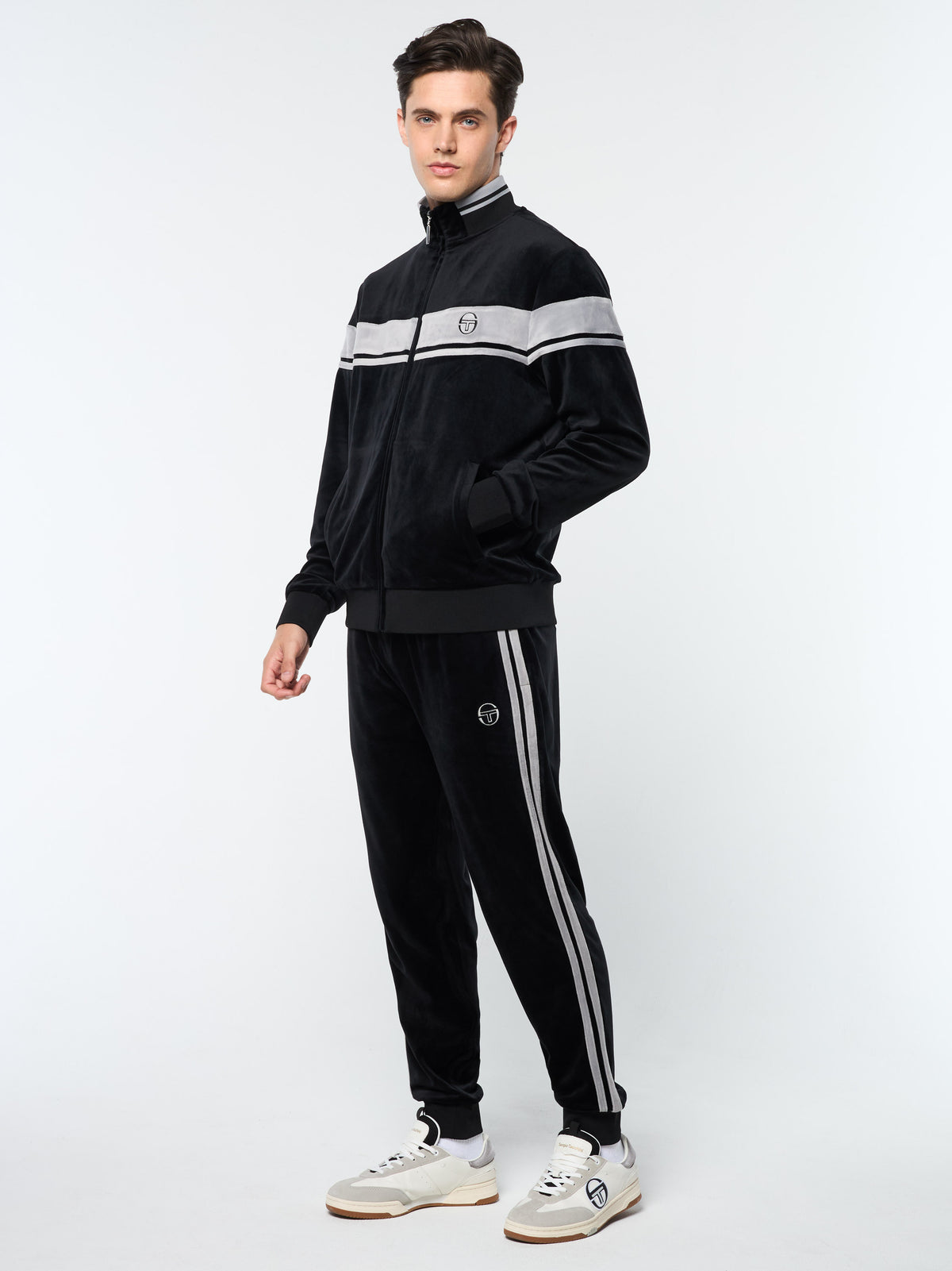 Three-quarter front view of the Damarindo Velour Track Jacket and pants in Black Beauty.