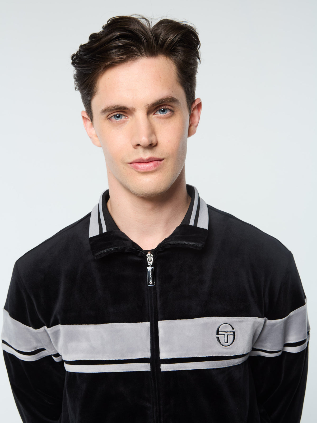 Close-up front portrait of the collar on the Damarindo Velour Track Jacket in Black Beauty.