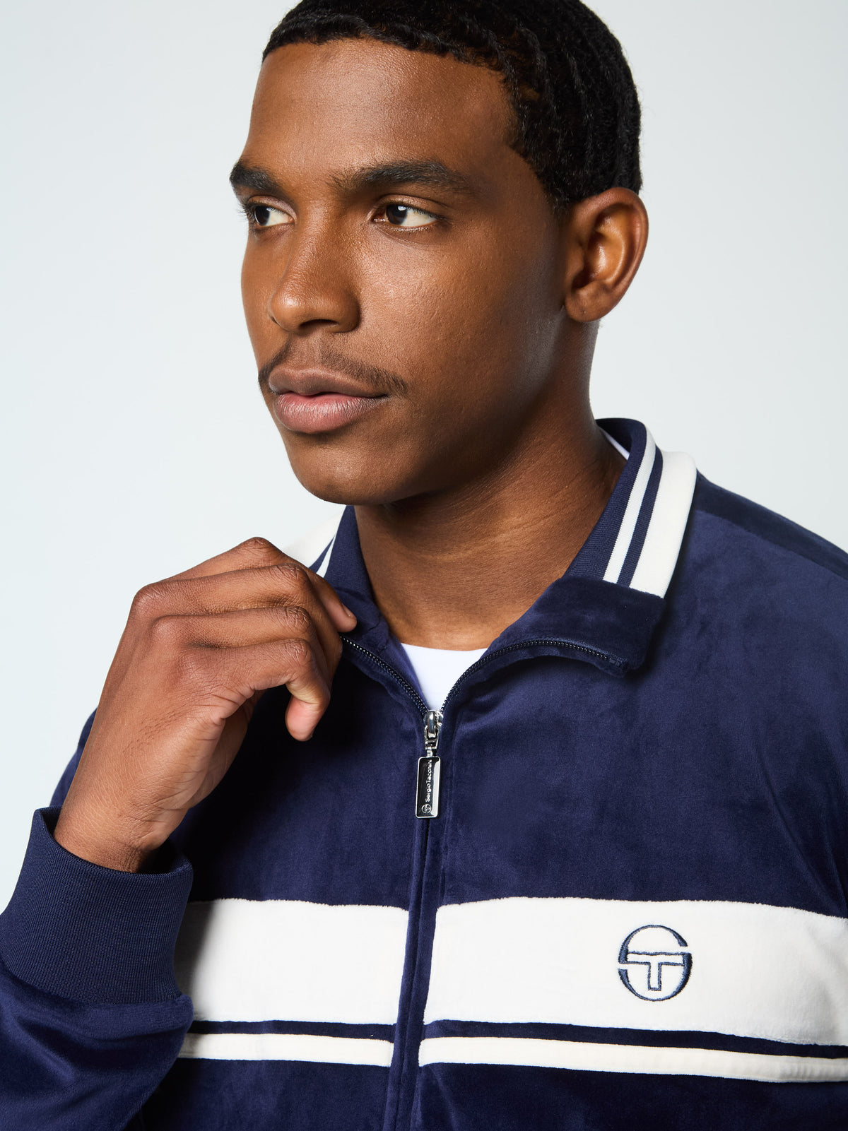 Close-up of the collar and zip on the Damarindo Velour Track Jacket in Maritime Blue.