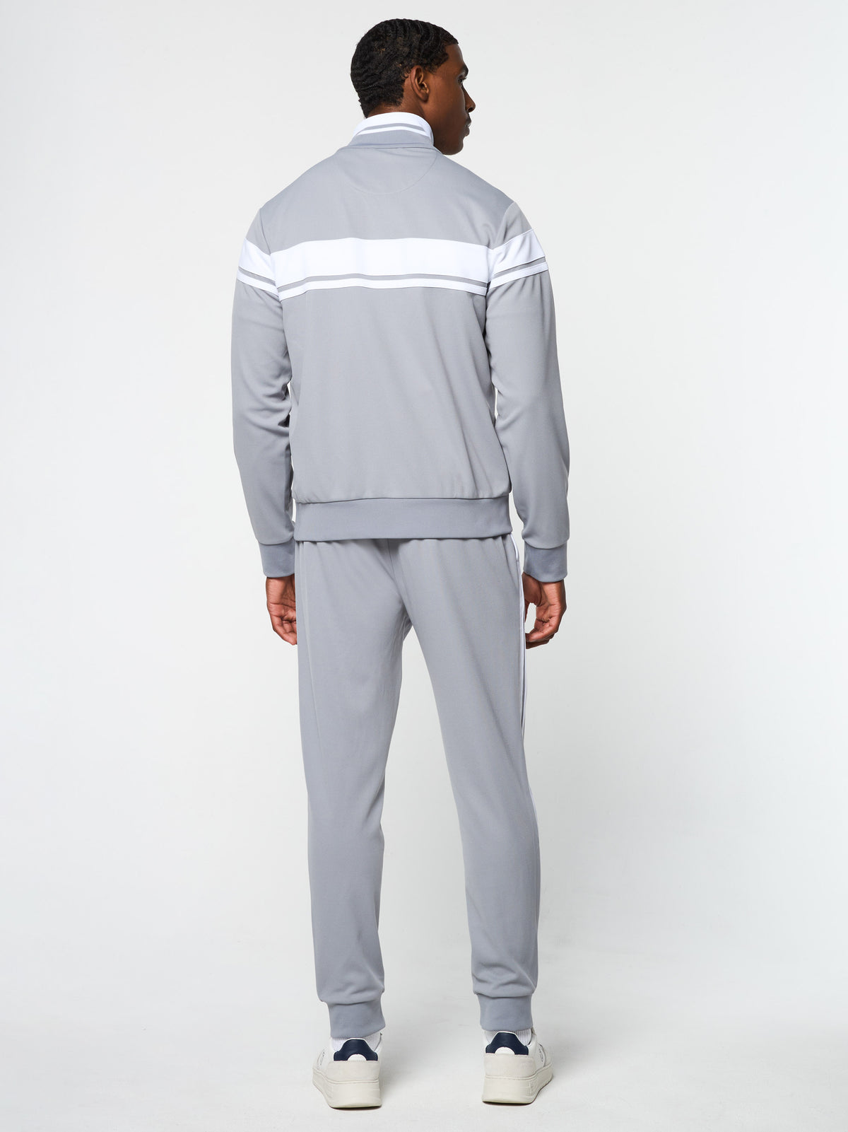 Full body back view of the Damarindo Track Jacket Archivio and pants in Sleet/White.