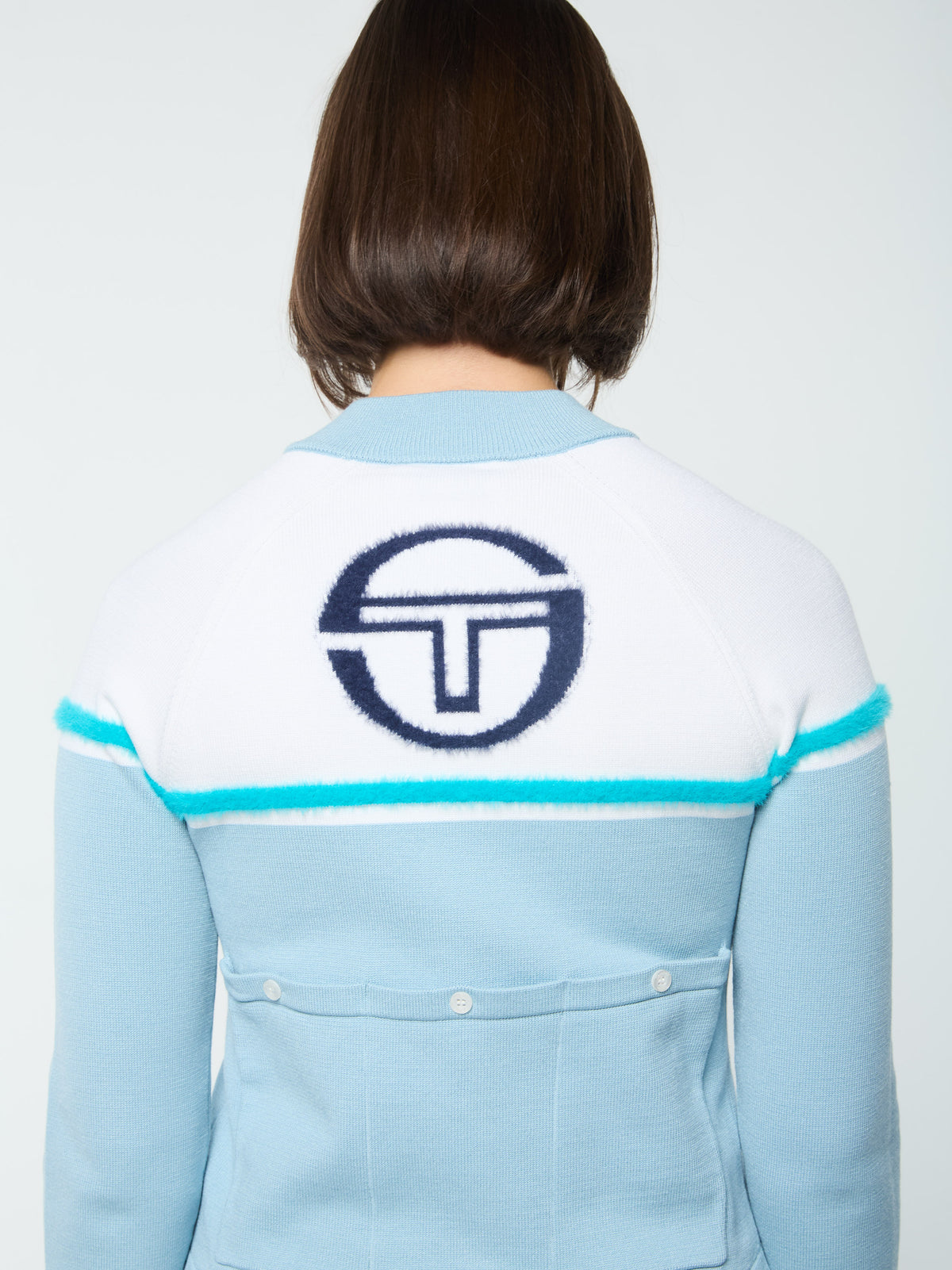 Close-up back view of the logo and pocket on the Ruota Cycling Jersey in Celestial Blue.