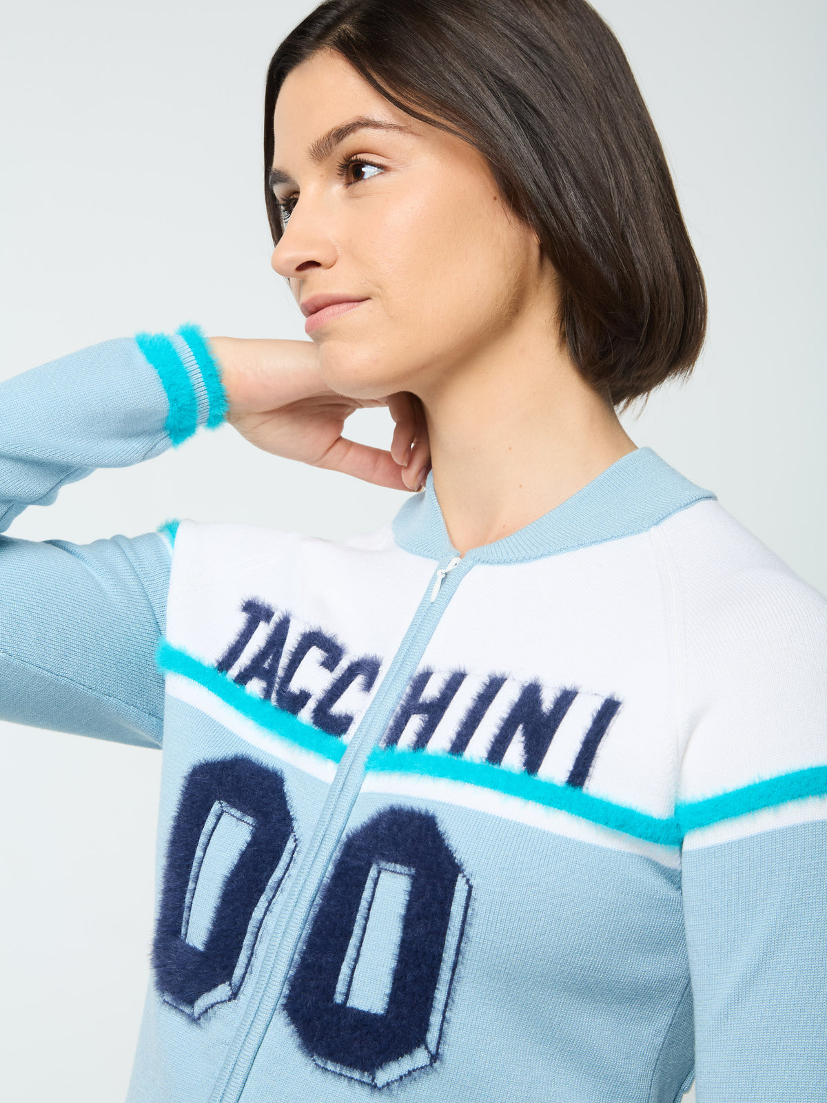 Close-up front portrait of the "Tacchini 00" varsity graphic on the Ruota Cycling Jersey in Celestial Blue.