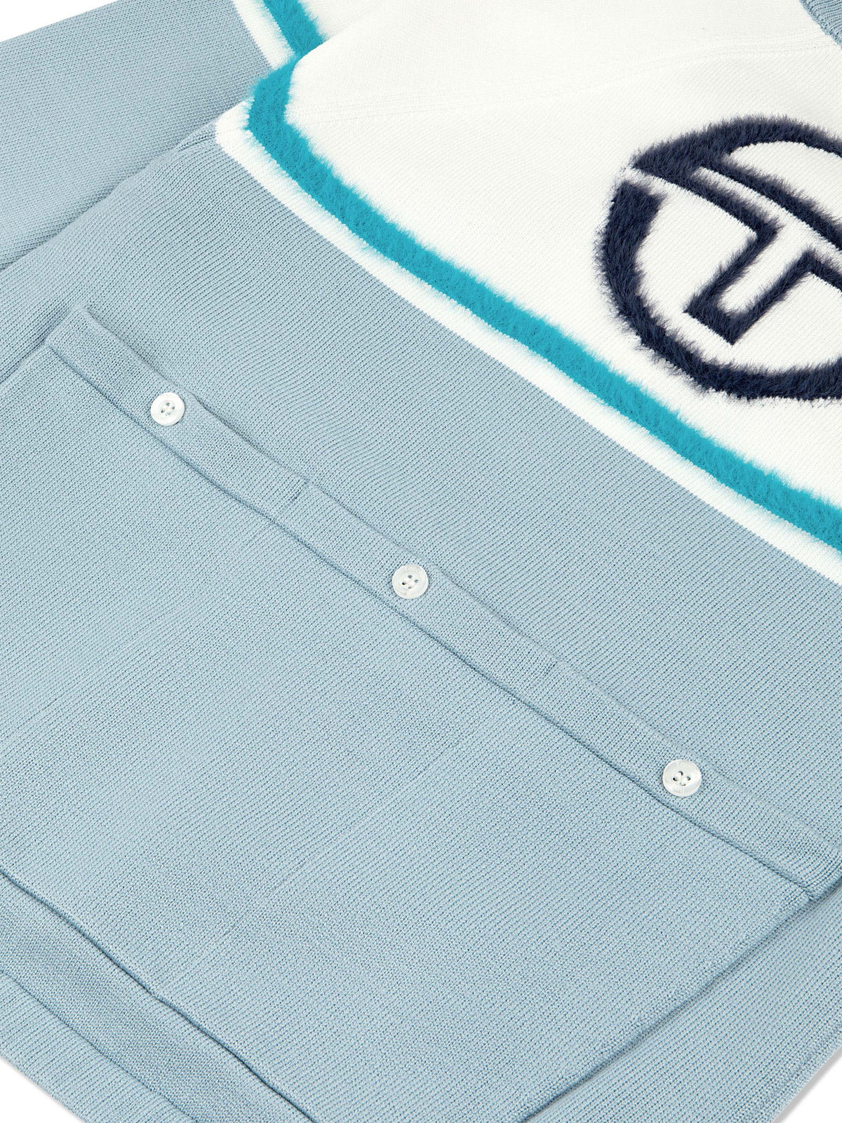 Close-up of the textured logo and buttoned back pocket on the Ruota Cycling Jersey in Celestial Blue.