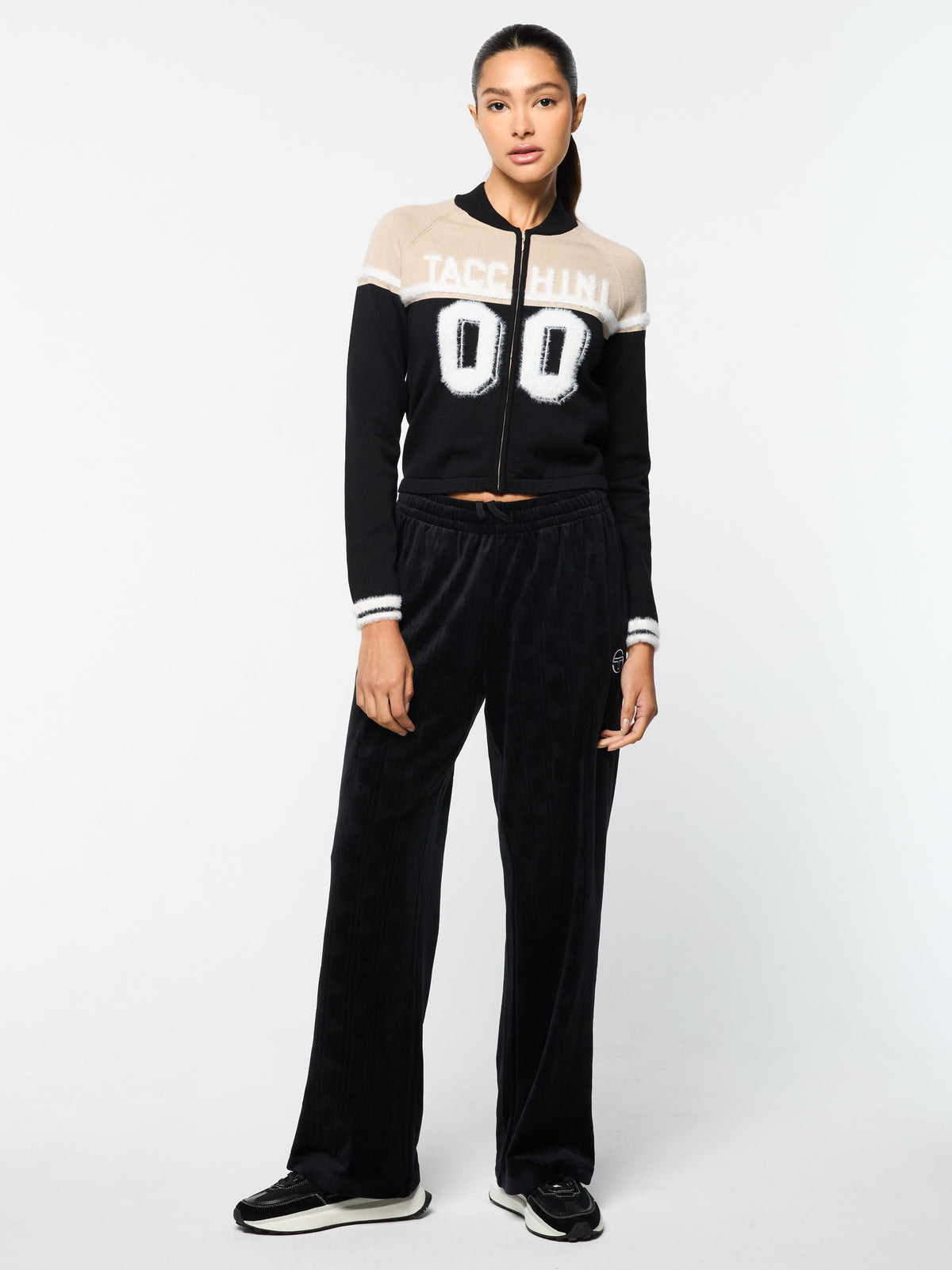 Full body front view of the Ruota Cycling Jersey in Black Beauty with wide-leg velour pants.