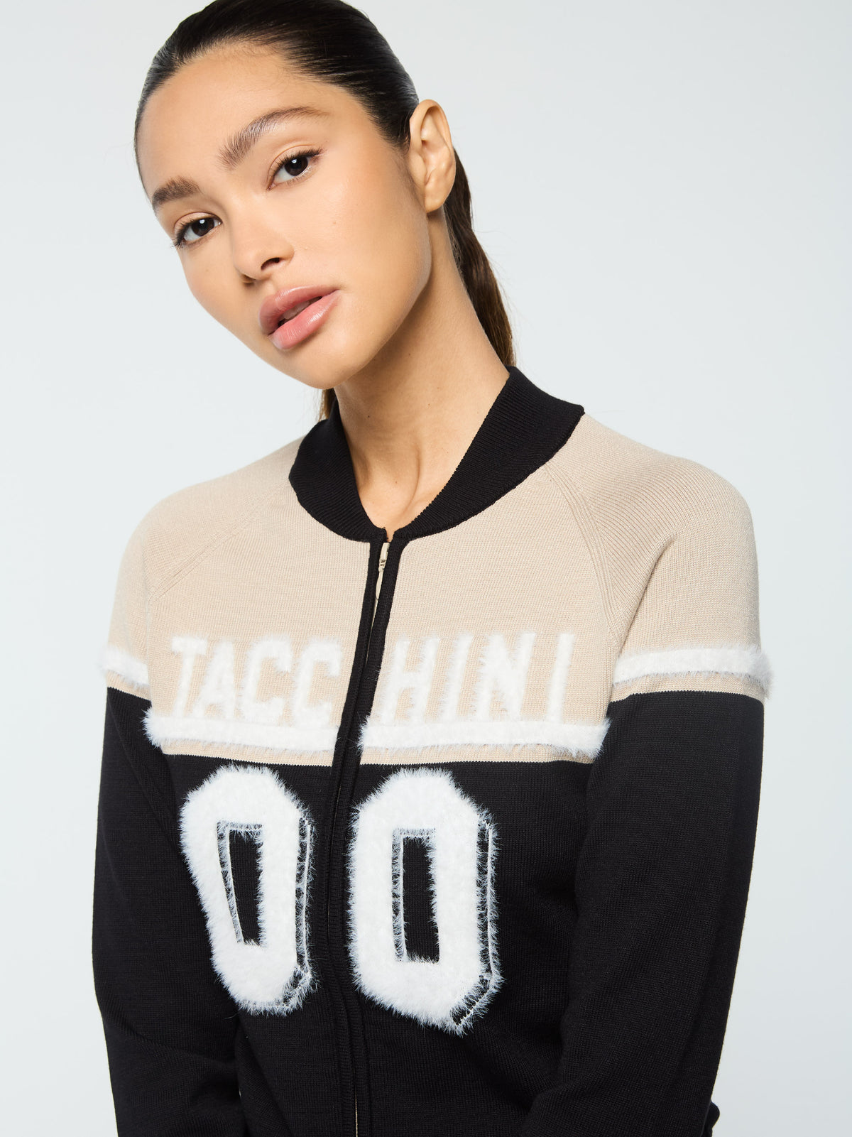 Close-up front portrait of the "Tacchini 00" varsity graphic on the Ruota Cycling Jersey in Black Beauty.