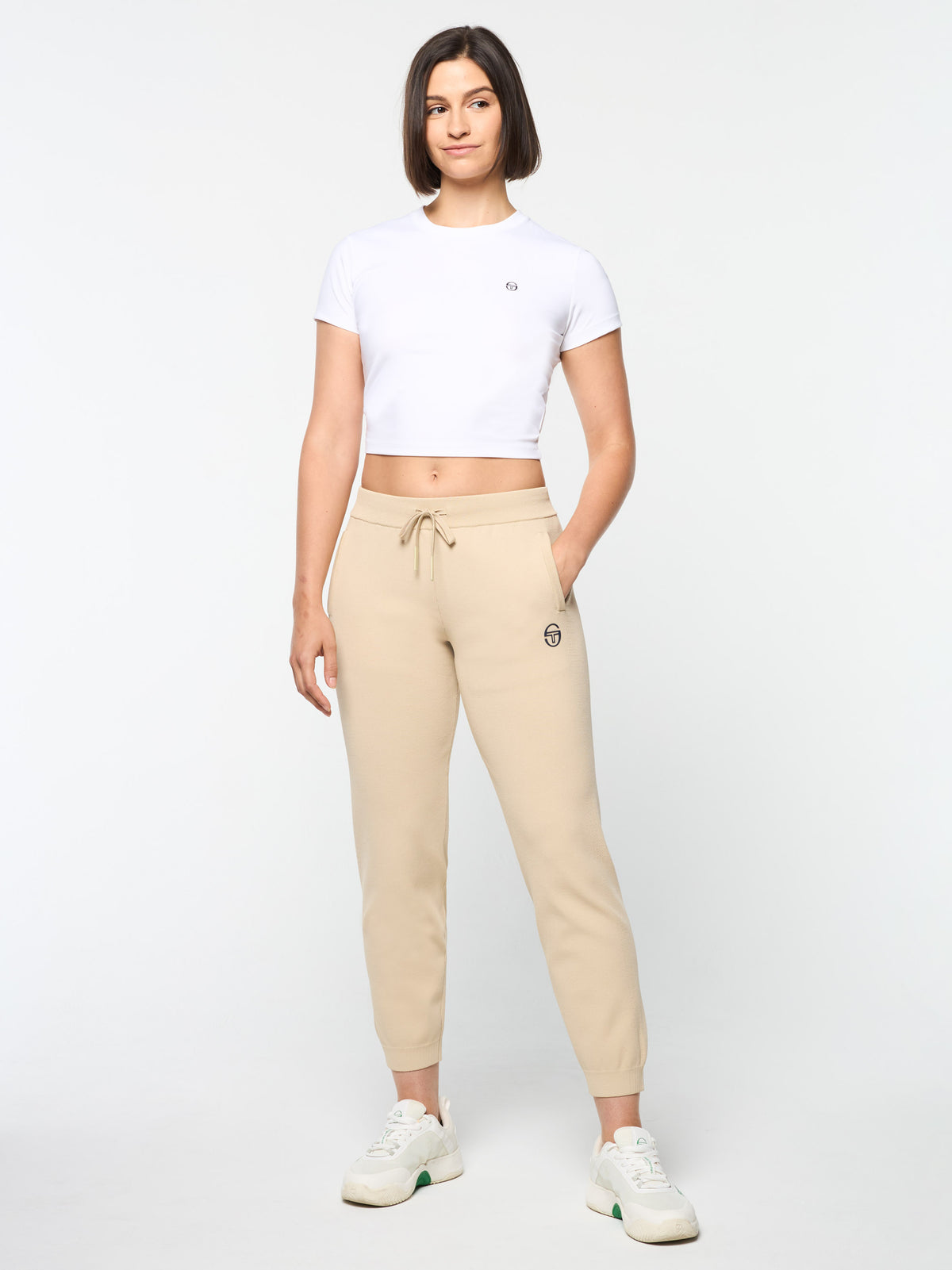 Model wearing the Rosolina Track Pant in Humus with a white cropped t-shirt, full body front view.