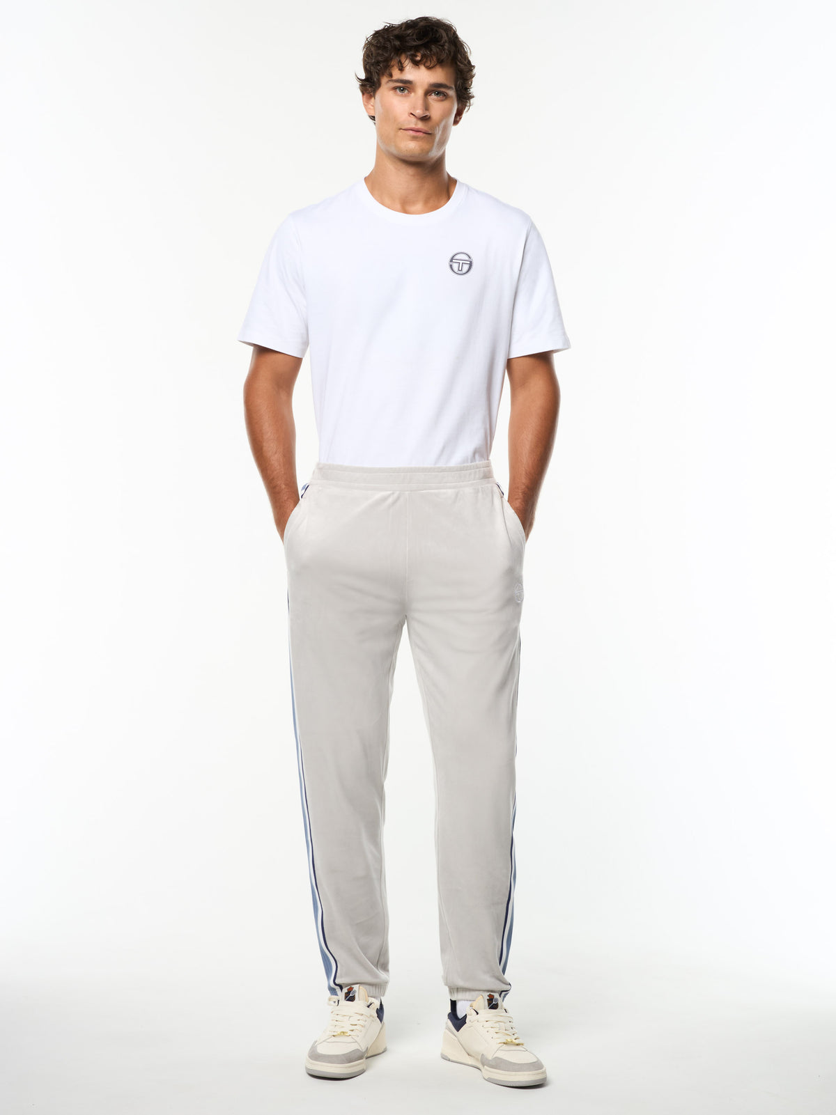 Model wearing the Linera Velour Track Pant in Quiet Gray with a white logo tee, full body front view.