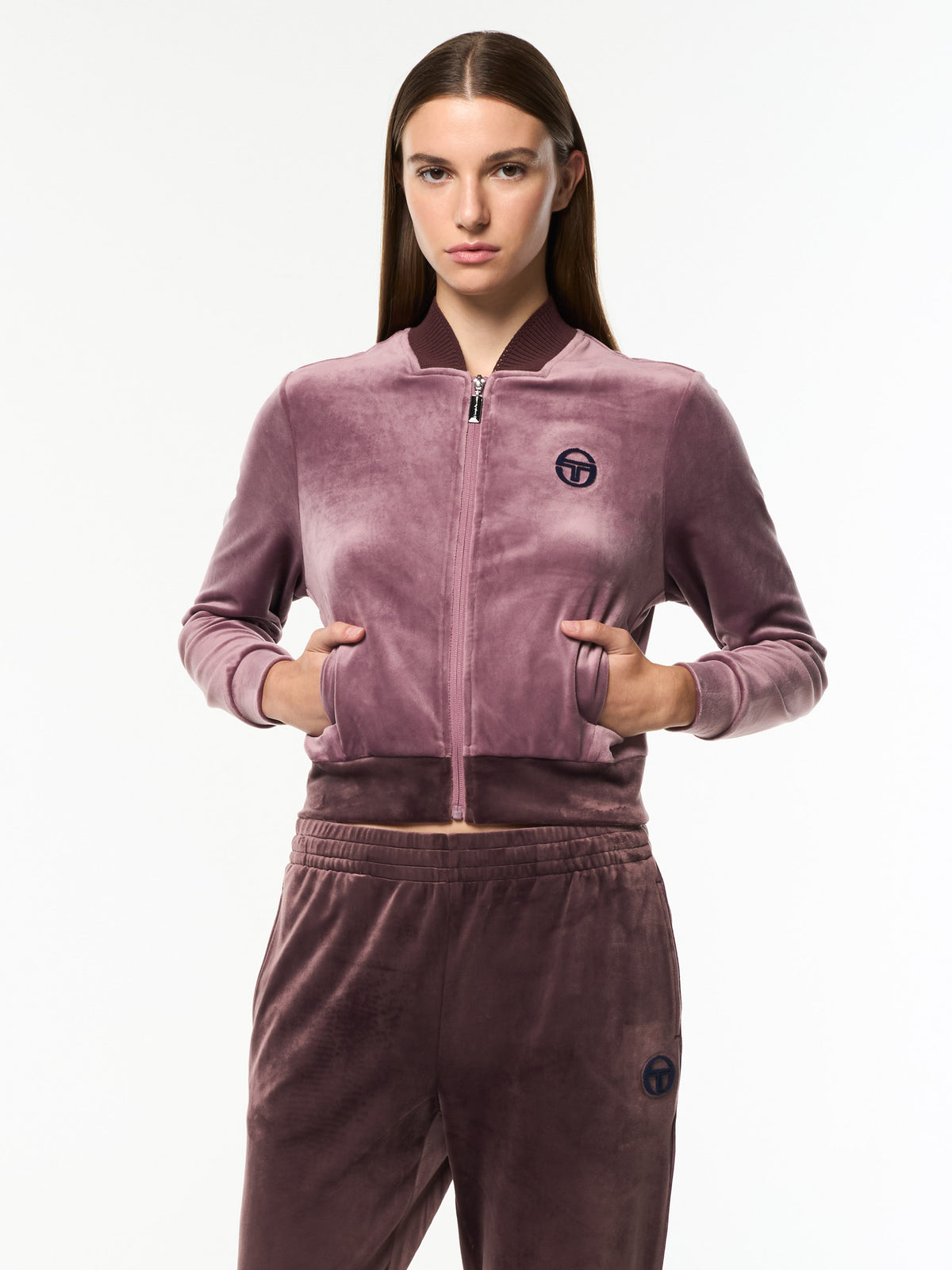 Model wearing the cropped Dalia Velour Track Jacket in Grape Shake with matching velour pants, front upper body view.