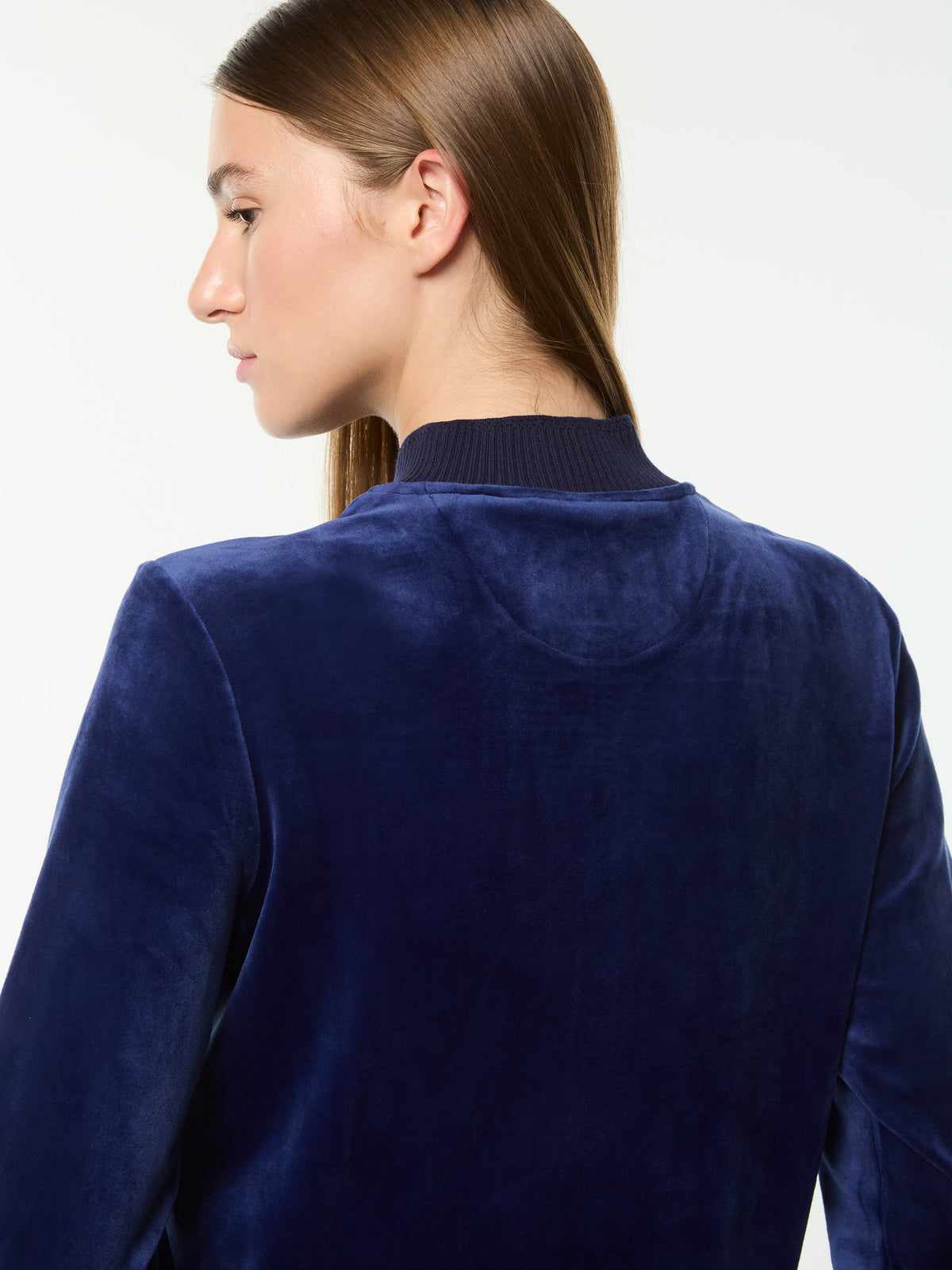 Close-up back view of the ribbed collar and velour texture on the Dalia Velour Track Jacket in Beacon Blue.