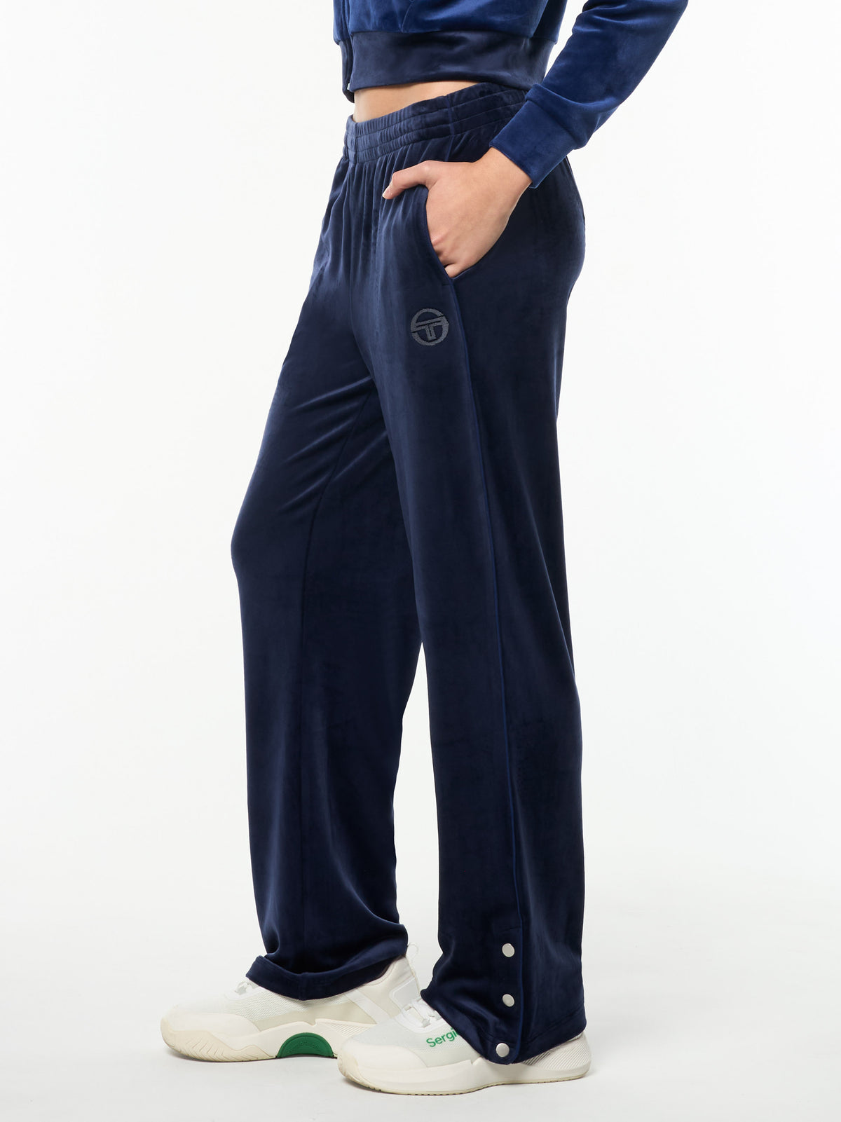 Side view of the Dalia Velour Track Pant in Maritime Blue, a straight-leg velour pant with snap-button hems.