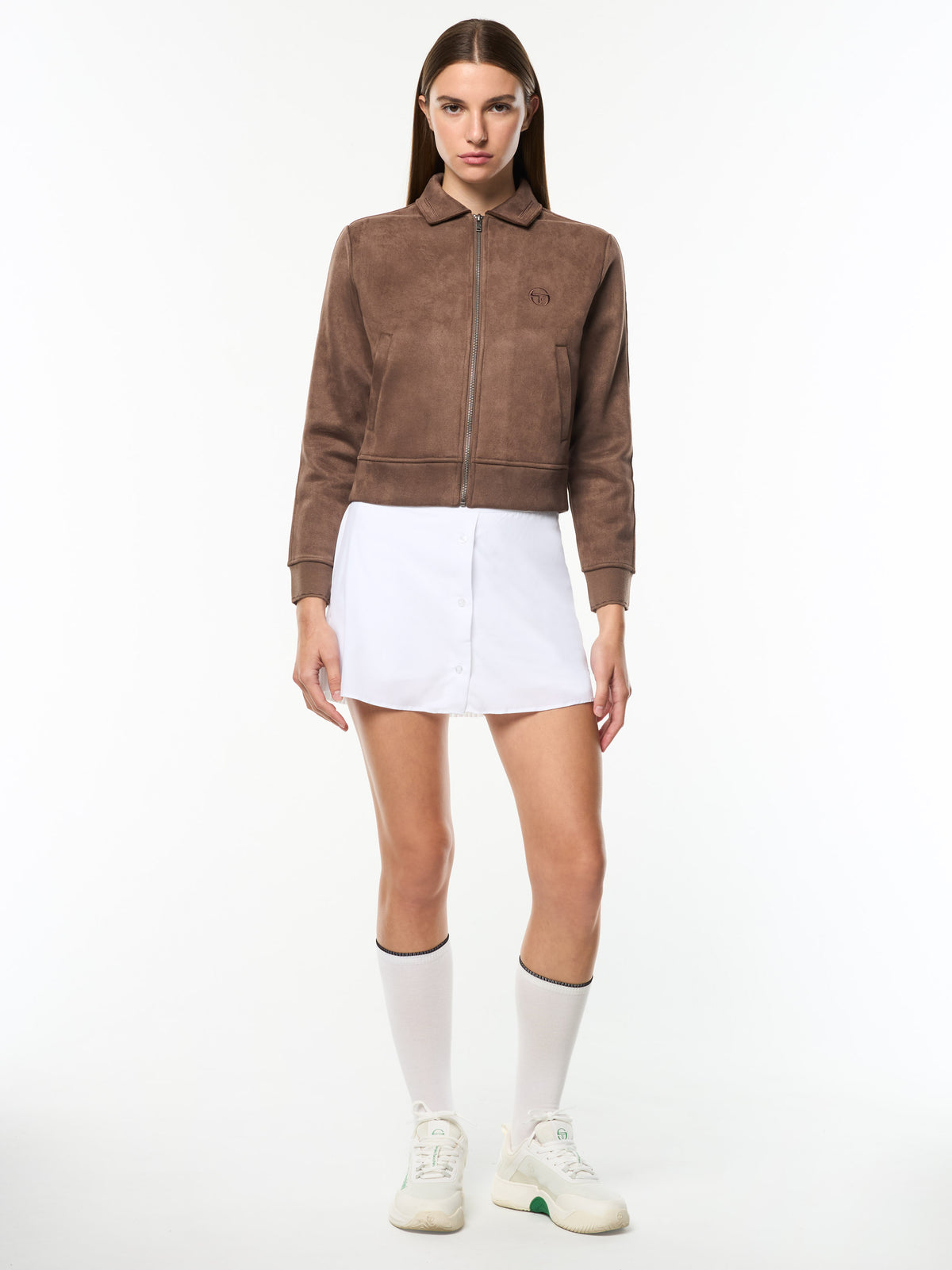 Model wearing the Women's Soffice Track Jacket in Chocolate Chip with a white tennis skirt, full body front view.