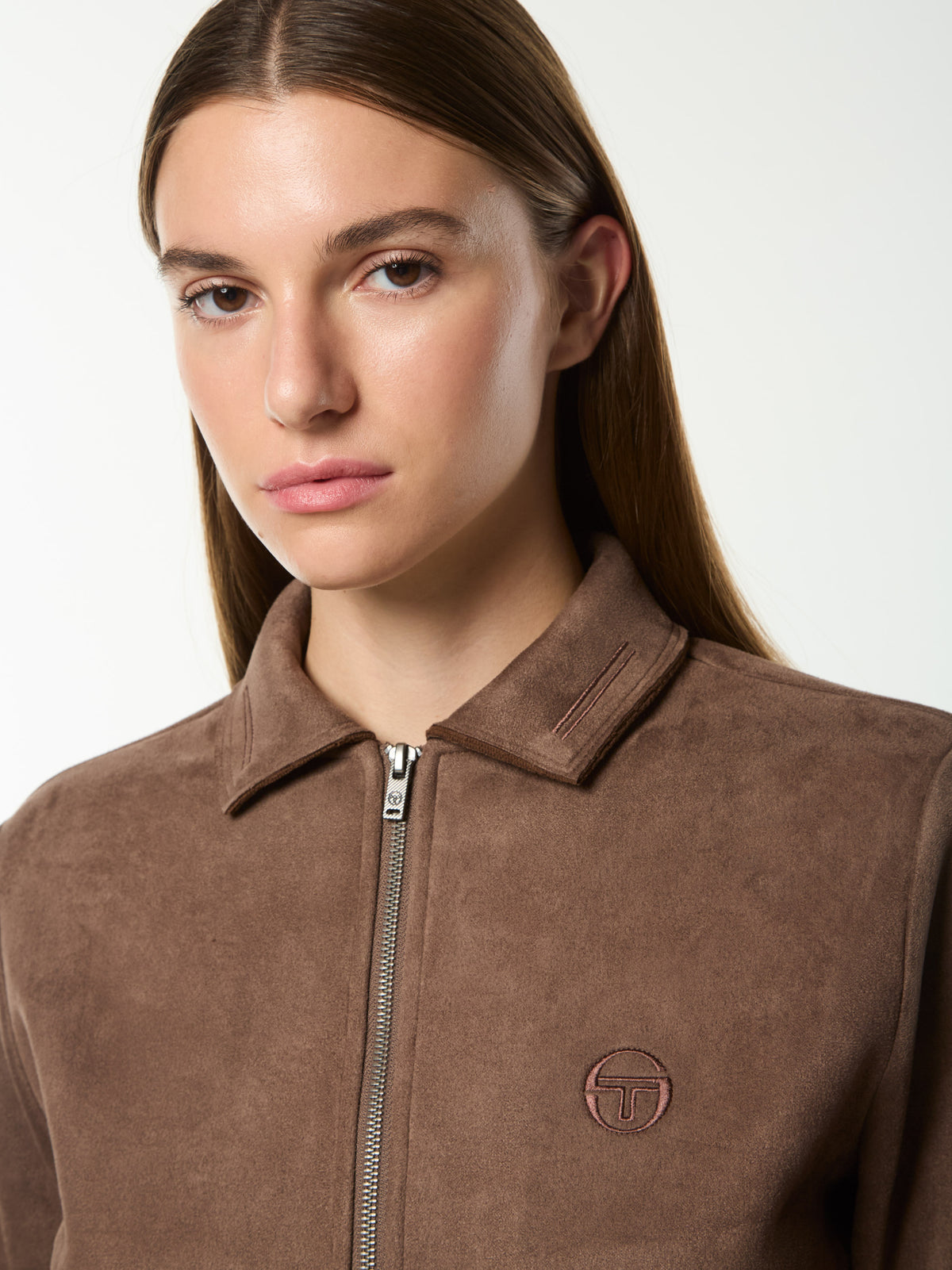 Close-up front portrait of the collar, zip and embroidered logo on the Women's Soffice Track Jacket in Chocolate Chip.
