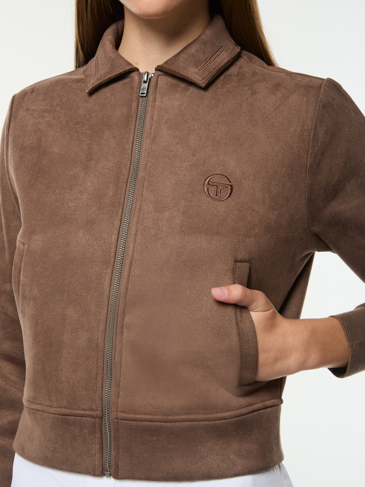 Close-up of the tonal chest logo and pocket on the Women's Soffice Track Jacket in Chocolate Chip.