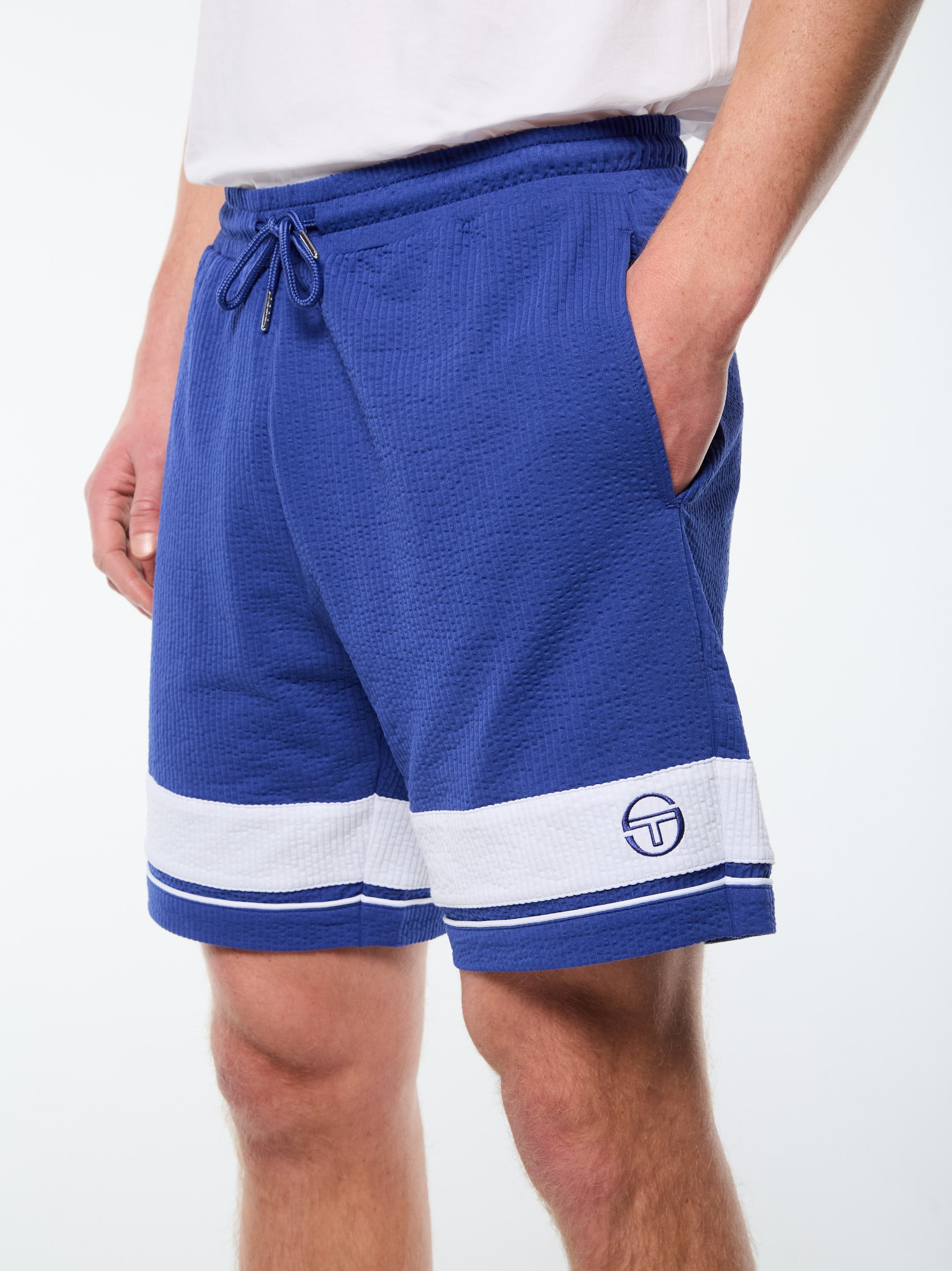Man wearing a cobalt blue cabana shorts with white striping.