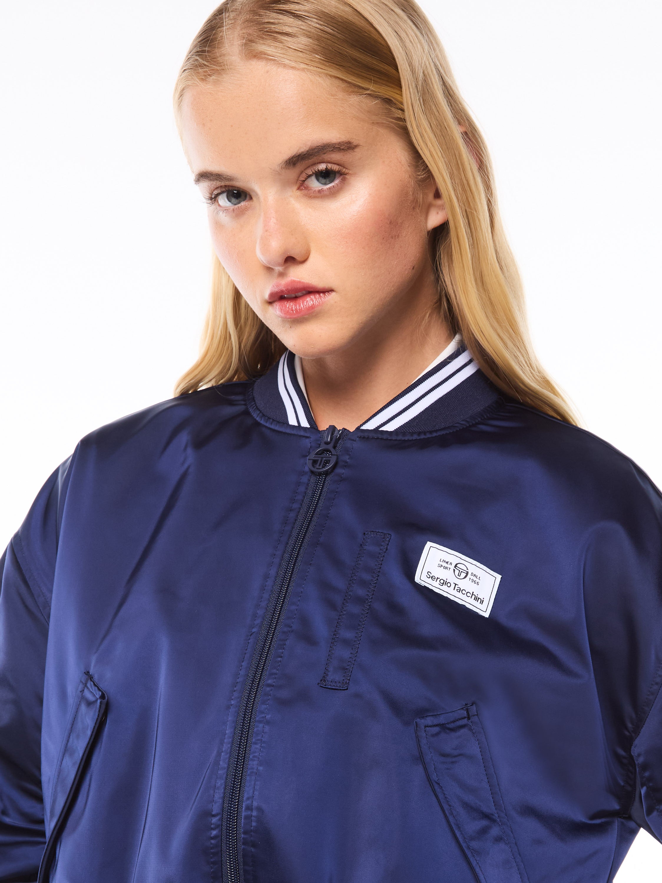 Woman wearing a navy blue bomber jacket.