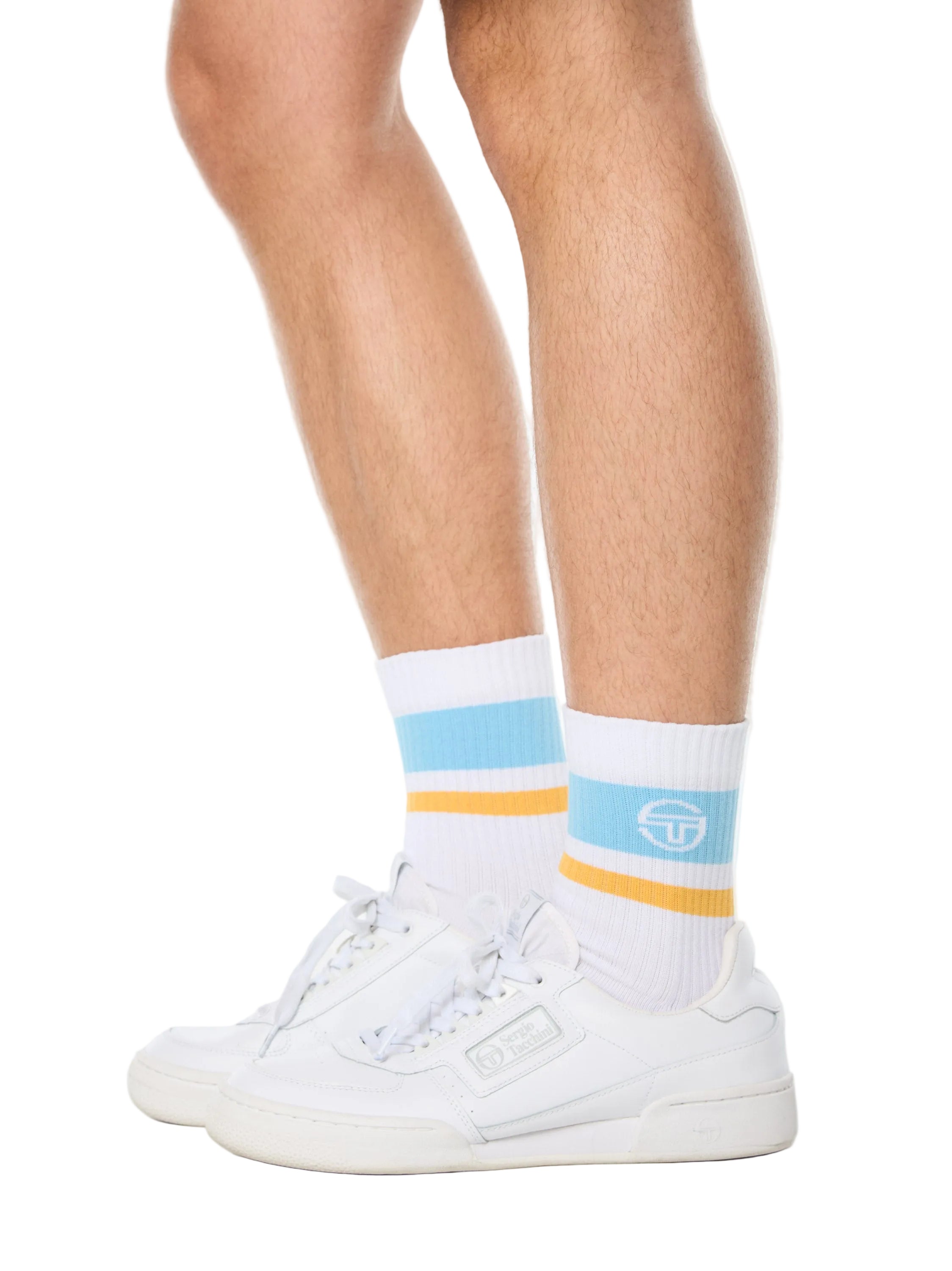 Man wearing white socks with baby blue and yellow stripes.