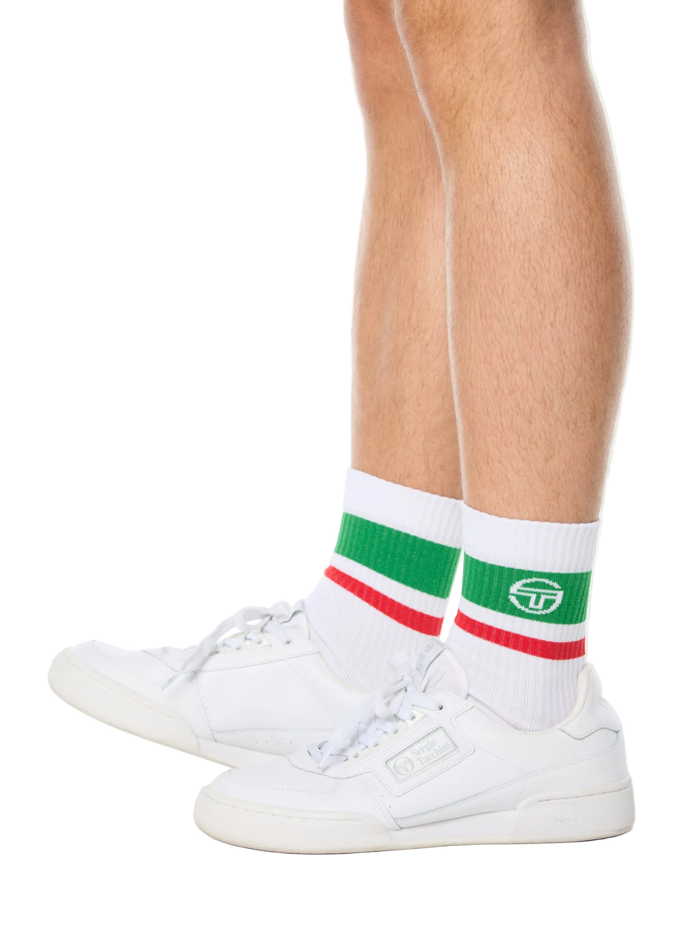 Man wearing white socks with green and red stripes.