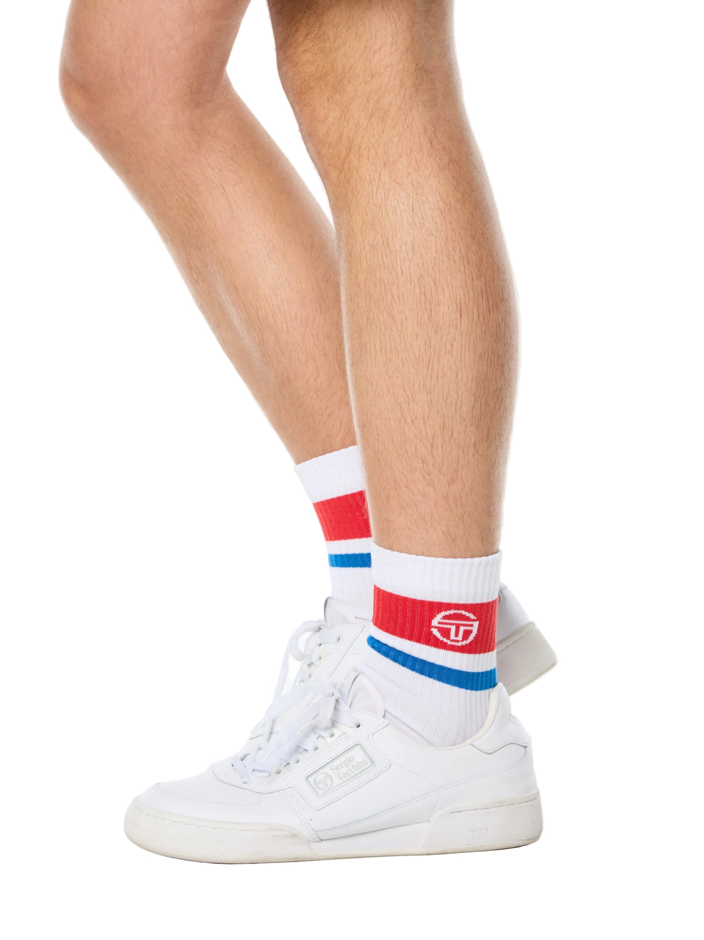 Man wearing white socks with red and blue stripes.