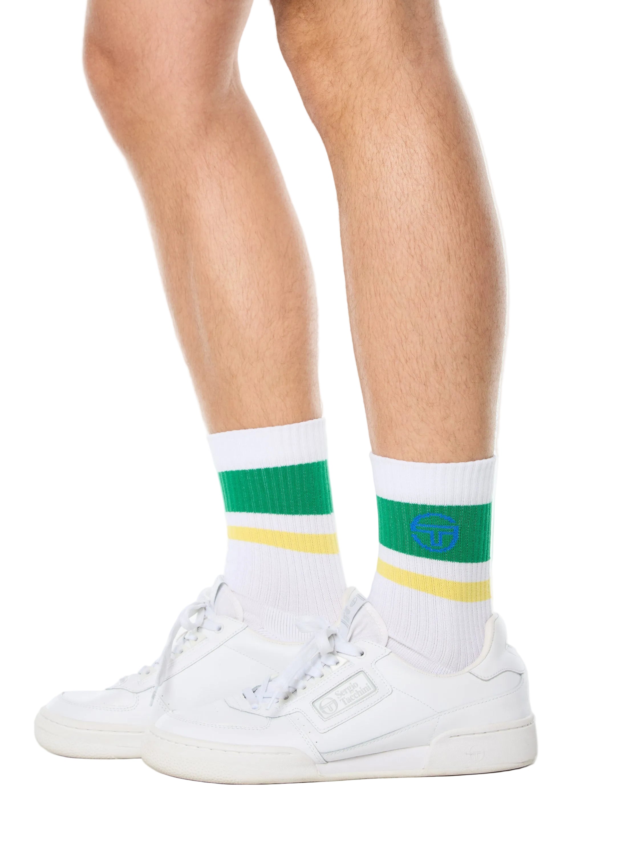 Man wearing white socks with green and yellow stripes.