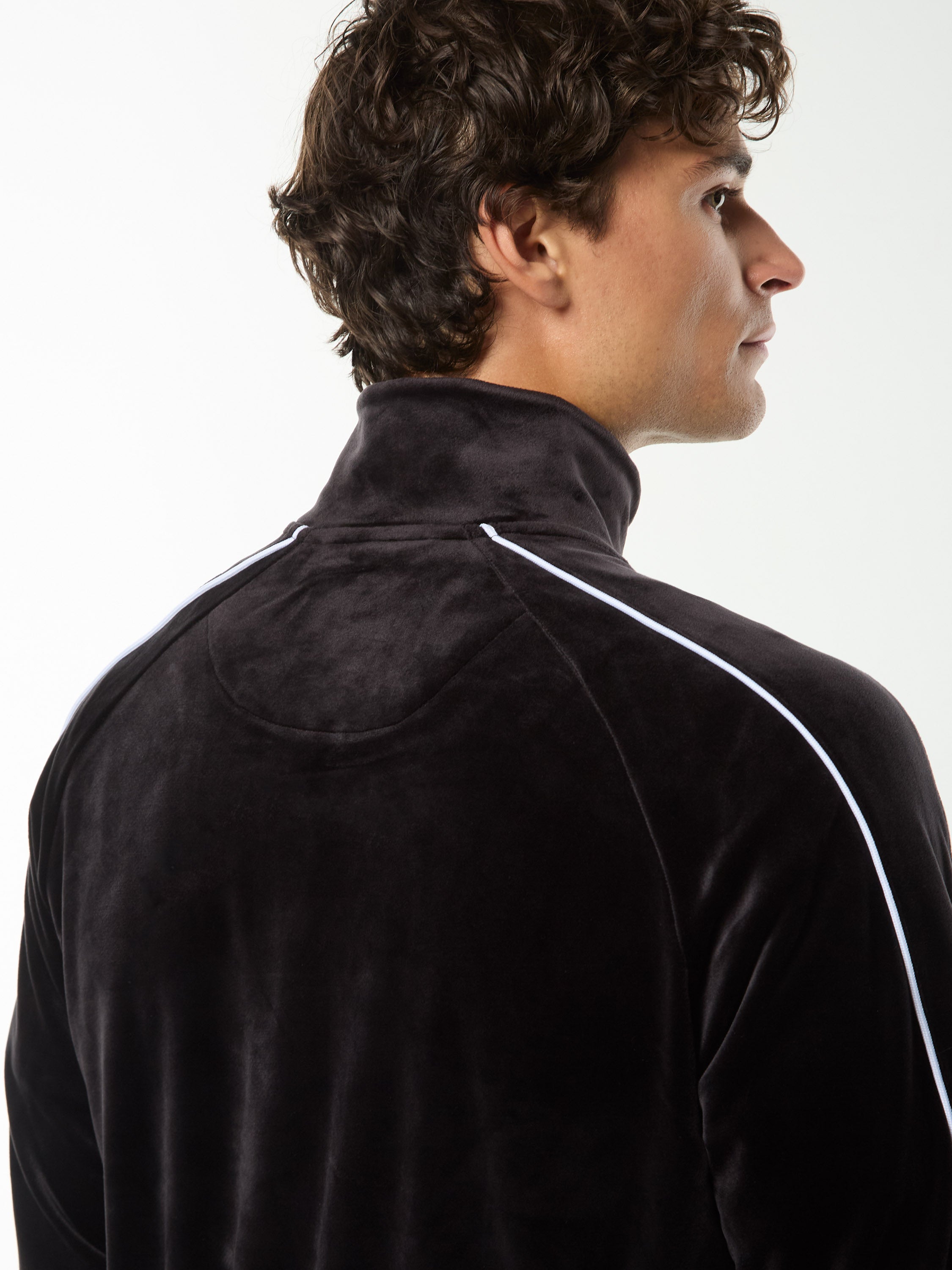 Close-up back view of the collar and white shoulder piping on the Lioni Velour Track Jacket in Black Beauty.