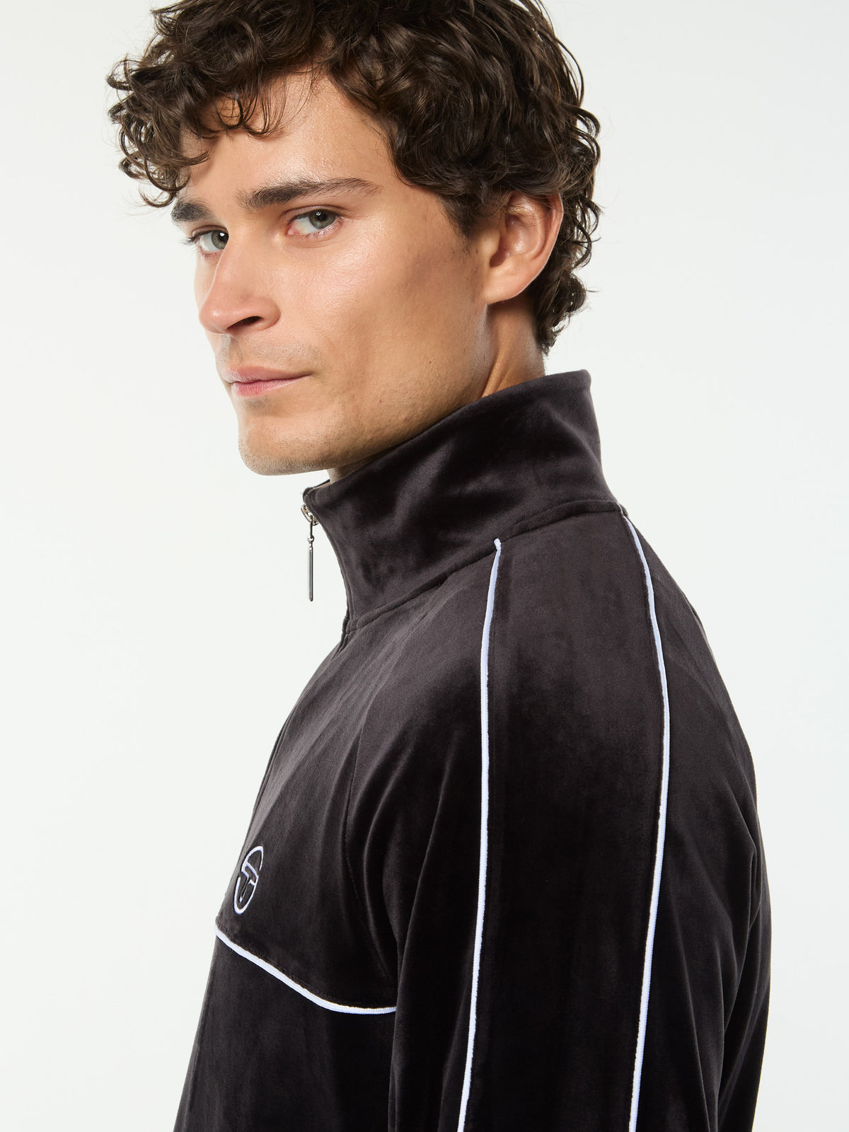 Side profile close-up of the stand collar and piping on the Lioni Velour Track Jacket in Black Beauty.