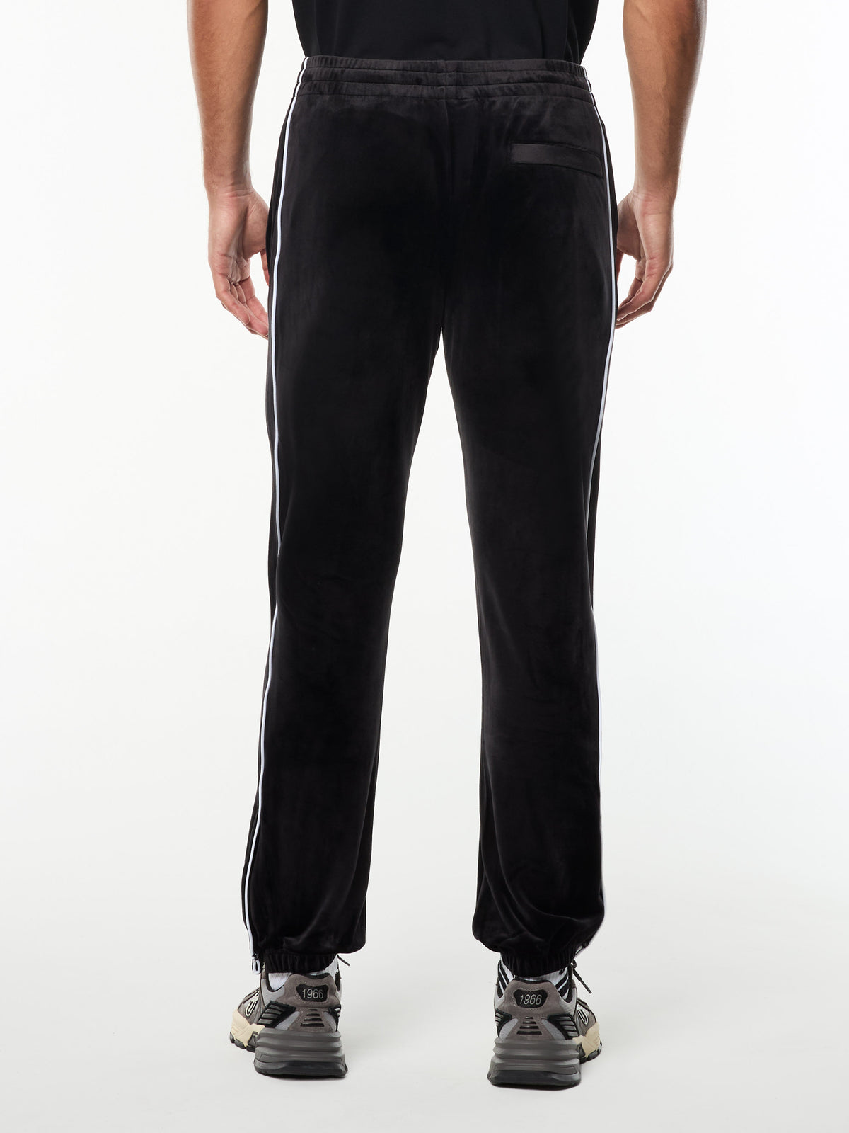 Back view of the Lioni Velour Track Pant in Black Beauty, showing the back pocket and ribbed cuffs.