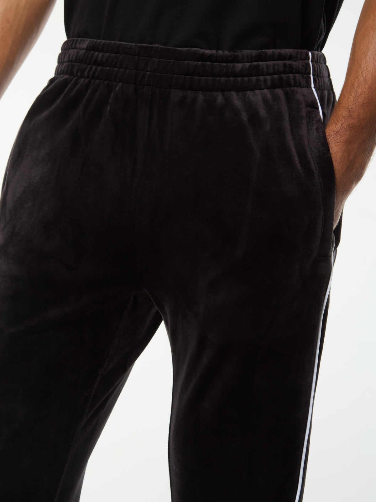 Close-up of the elastic waistband and side piping on the Lioni Velour Track Pant in Black Beauty.