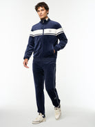 Full body angled view of the Damarindo Velour Track Jacket and matching pants in Maritime Blue.