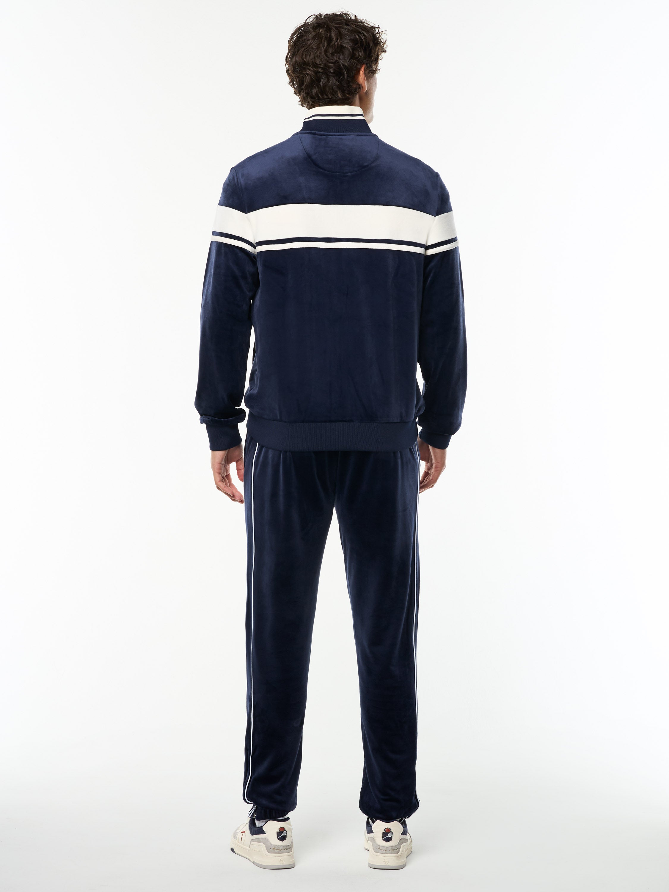 Full body back view of the Damarindo Velour Track Jacket and matching pants in Maritime Blue.
