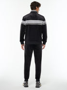 Full body back view of the Damarindo Velour Track Jacket and matching pants in Black Beauty.