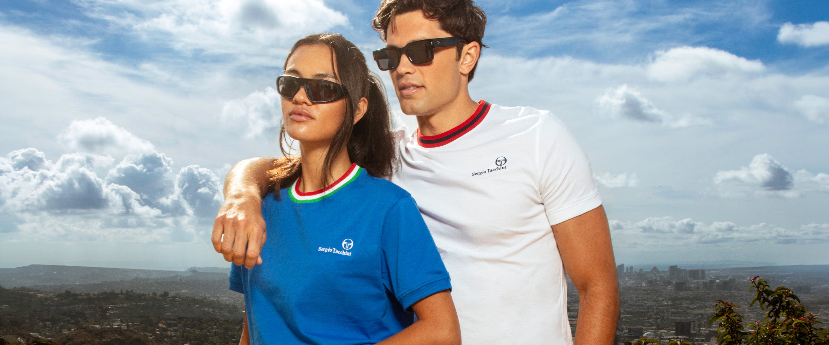 Woman and man standing with a scenic background behind them